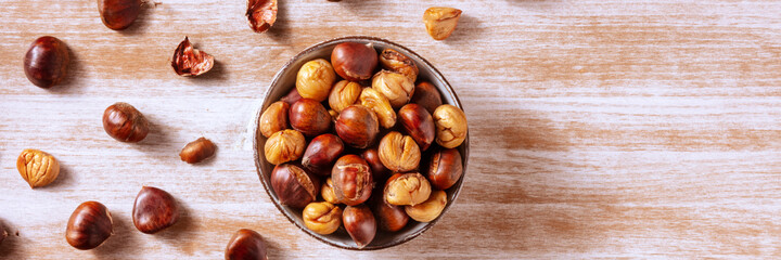 Chestnuts panorama, shot from the top on a rustic wooden background with a place for text