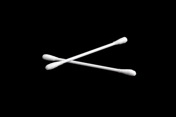 Two white cotton swabs. Close-up. Selective focus. Isolated on black background