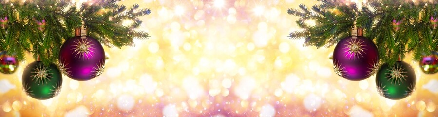 Obraz premium Christmas ornaments and New Year decor. Christmas balls, gold stars on fir branches on festive bokeh background. Winter holiday greeting card.