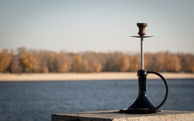 hookah sheesha with a glass flask and a clay bowl on the street. A traditional oriental getaway for relaxation