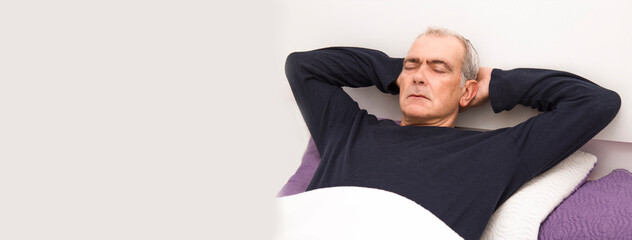 relaxed man sleeping in bed with copy space