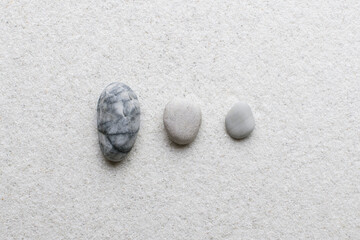 Fototapeta na wymiar Marble zen stones stacked on white background in stability concept
