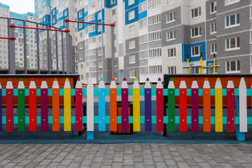 a fence made of pencils in the yard for children to study