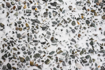 stones with snow as a texture element on the ground