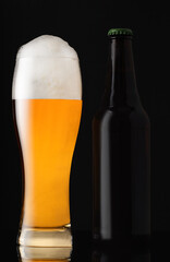 mug full of beer with a brown bottle