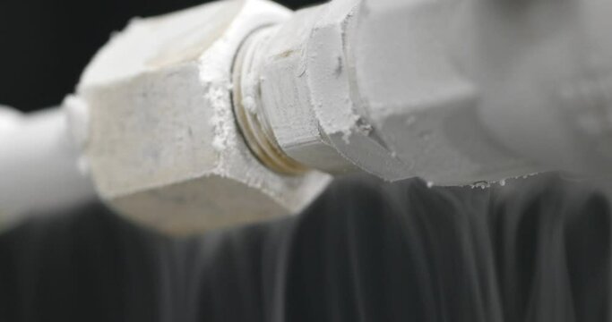 Liquid nitrogen tank  with frozen transfer pipes, close up shot, real time, shallow depth of field
