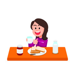 Happy little girl has breakfast with milk and bread