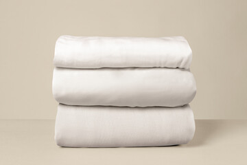 Stacked white bed linen
