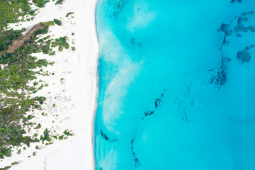 Fototapeta na wymiar View from above, stunning aerial view of a white sand beach bathed by a turquoise water. Rena Majore, Sardinia, Italy.