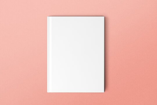 Blank white book cover on pink background