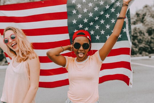 Women celebrating Independence Day, holding American flag
