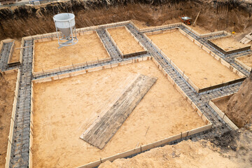 Foundation of future house. Pouring foundation with cement on construction site with crane, aerial view.