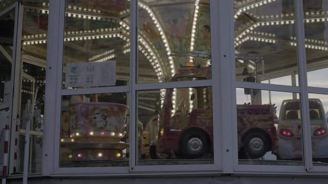 Low Angle: Long Shot: Spinning Italian Carosel Merry Go Round 