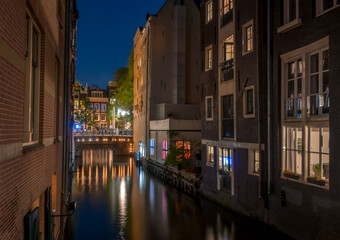 Fototapeta na wymiar Night Canal Between Amsterdam Houses
