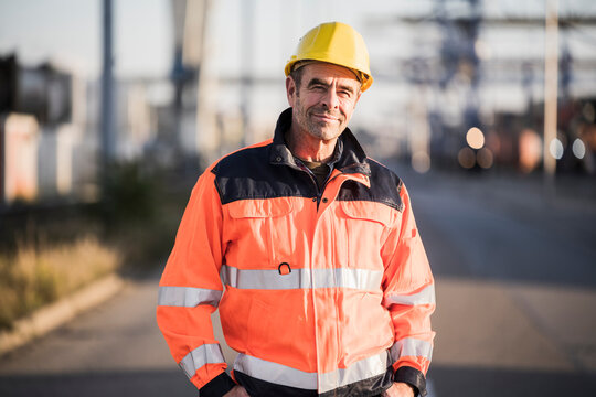 Confident male dock worker at industry