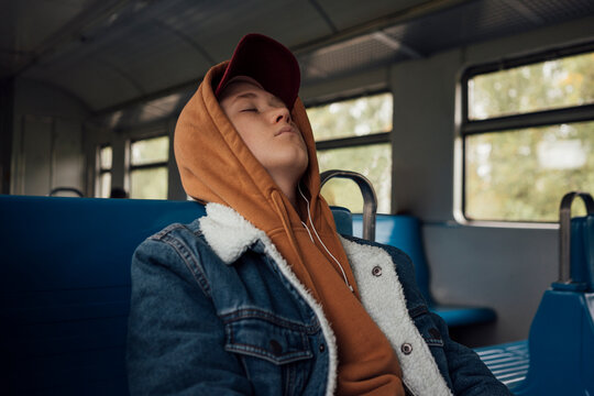 Tired boy sleeping while travelling in train