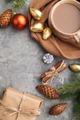 Christmas or New Year composition. Decorations, cones, fir and spruce branches, cup of coffee, on a gray concrete background. Top view, copy space.