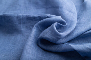 Fragment of blue linen tissue. Side view, natural textile background.