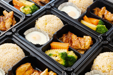 Japanese bento box, Japanese food lunch boxes in plastic packages. Fried rice with Teriyaki chicken.