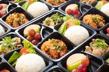 Modern Thai food lunch boxes in plastic packages.