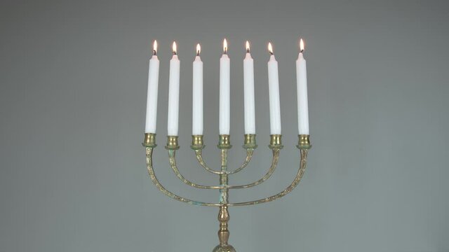 Lighting The Menorah. Stop Motion And Time Lapse 4k. Green Background. Religion And Culture. Cultural Symbols. 