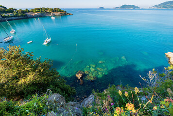 Beautiful bay and seascape in front of the Lerici town, Gulf of La Spezia, Liguria, Italy, southern Europe. On horizon the small town of Porto Venere or Portovenere and the Tino and Palmaria island.