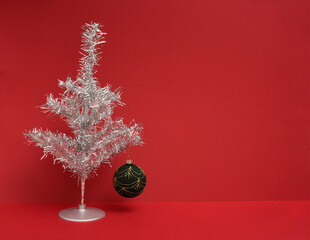 Silver Tinsel Christmas Tree on red background
