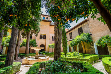 Courtyard with fountain and treesin Alhambra palace complex, Granada, Andalusia, Spain