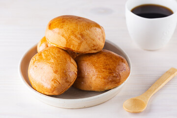 Homemade pies with a cup of coffee on a wooden table. © 7707601