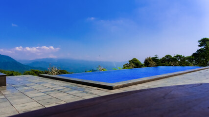 infinity swiming pool with stunning view of hills.