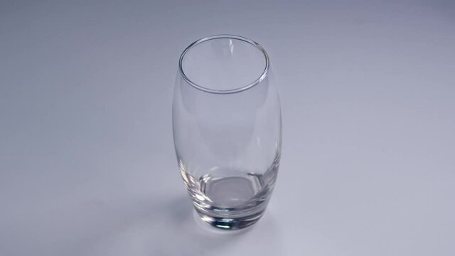 Glass of milk in slow motion. Pouring milk in a transparent glass. Footage in 4K