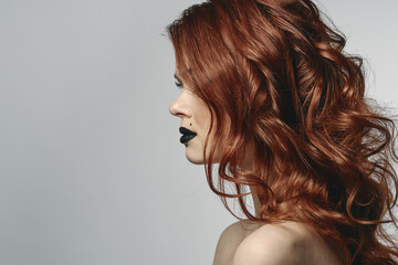 red-haired woman with bare shoulders bright makeup base zodiac sign horoscope