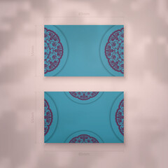 Business card in turquoise color with a mandala in purple pattern for your business.