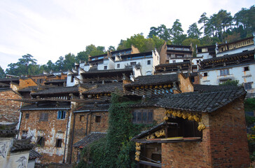 Fototapeta na wymiar Gray roofs with white or brown walls. Ancient buildings in Huangling Village. An ancient Huizhou architectural settlement in Huangling Village, Wuyuan, Jiangxi, China.