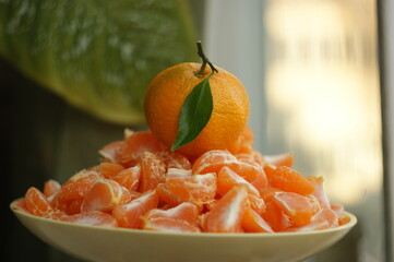 ripe and juicy tangerine (mandarin). fresh tangerine with leaf on white, closeup