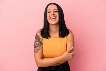 Fototapeta premium Young caucasian woman with one arm isolated on pink background laughing and having fun.
