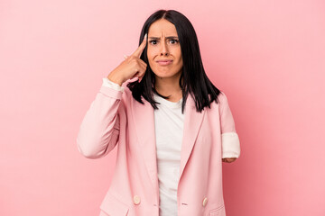 Young caucasian woman with one arm isolated on pink background showing a disappointment gesture with forefinger.