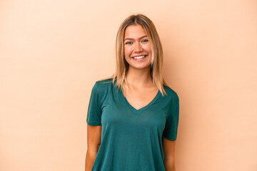 Obraz premium Young caucasian woman isolated on beige background happy, smiling and cheerful.