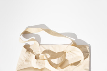 Eco-friendly cotton reusable bag on white background, flat lay, eco shopping