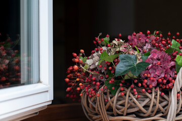 Fototapeta na wymiar Fragment of autumn flower arrangement in basket