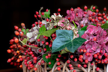 Fragment of autumn flower arrangement in basket