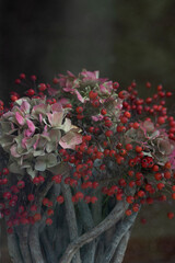 Fototapeta na wymiar Autumn arrangement in basket with hydrangea and rosehips