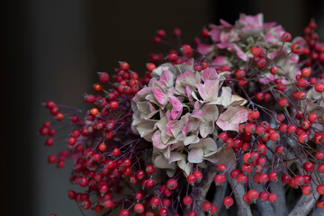 Fragment of autumn flower arrangement in basket