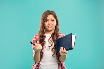 confused kid hold notebook on blue background, childhood