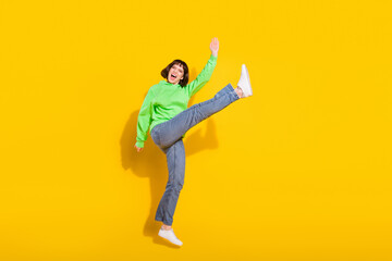 Full length body size view of nice crazy cheerful girl jumping fooling isolated over bright yellow color background