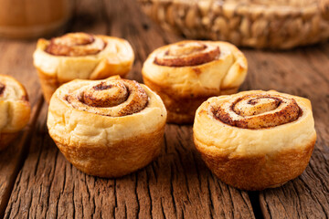 Cinnamon rolls on wooden background.