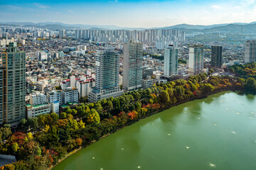 Aerial view of Seokchon lake and surrounding buildings with autumn colors, Jamsil, Songpa-gu, Seoul, South Korea.