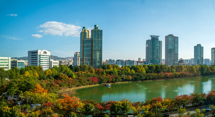 Seokchon lake and surrounding buildings with autumn colors, Jamsil, Songpa-gu, Seoul, South Korea.