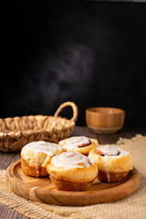 Cinnamon rolls on wooden background.