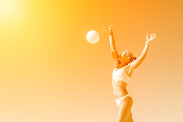 Young girl playing volleyball on the beach. Professional sport concept
